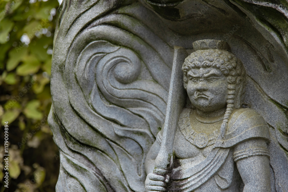 A religious stone statue of Acala at Japanese buddhism temple A religious stone statue of Acala at Japanese buddhism temple