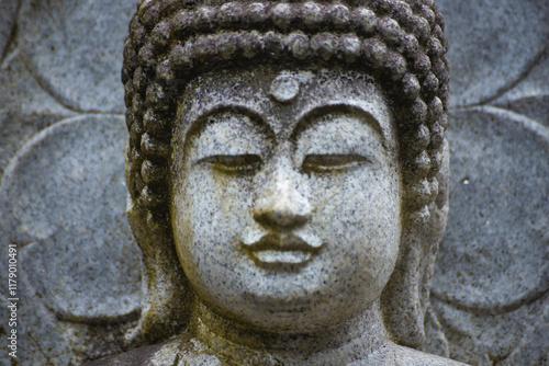 A religious stone statue of Akshobhya at Japanese buddhism temple photo