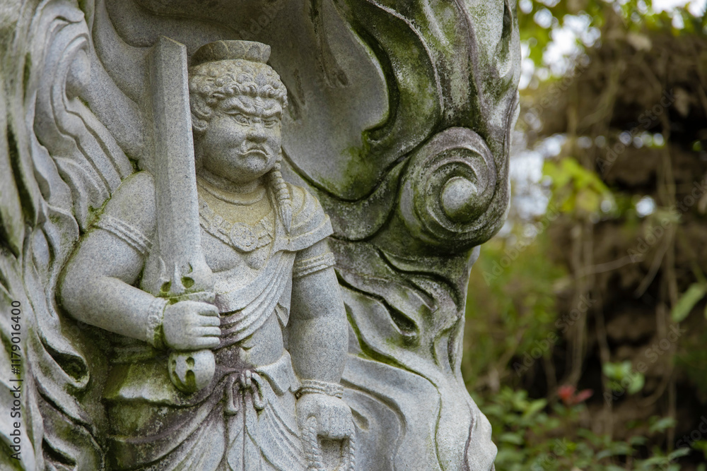 A religious stone statue of Acala at Japanese buddhism temple A religious stone statue of Acala at Japanese buddhism temple