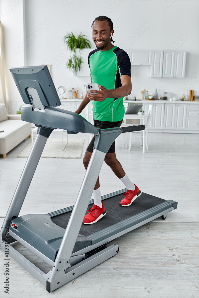 Fototapeta premium Young african american man enjoying a workout at home while staying connected and active