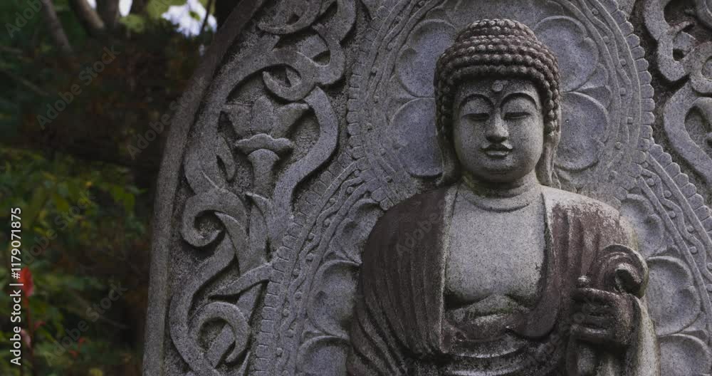 A religious stone statue of Akshobhya at Japanese buddhism temple A religious stone statue of Akshobhya at Japanese buddhism temple