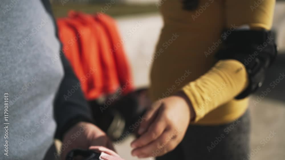 Close-up of adult hands assisting a child in securing protective gear, emphasizing care and safety in outdoor activities Close-up of adult hands assisting a child in securing protective gear, emphasizing care and safety in outdoor activities