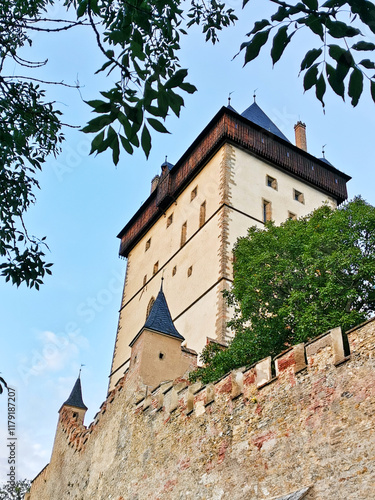 A detailed view of one of the towers of Karlstejn Castle from below.