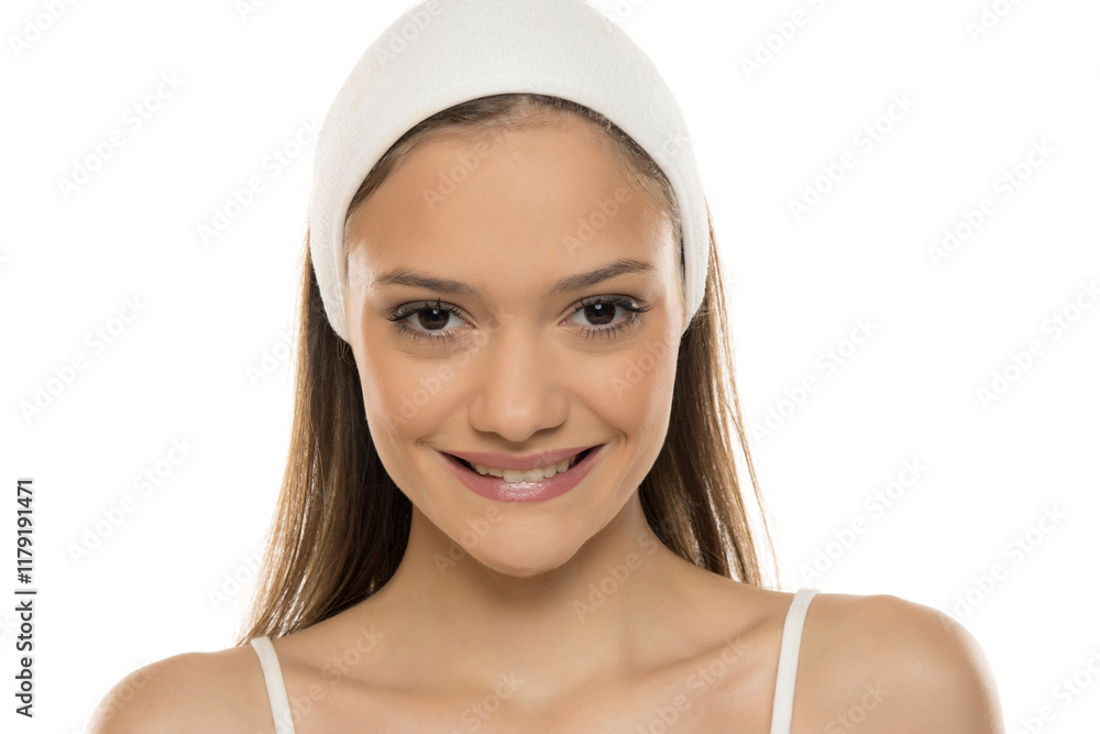 Headshot of a young smiling woman with makeup and scarf on a white studio background Headshot of a young smiling woman with makeup and scarf on a white studio background