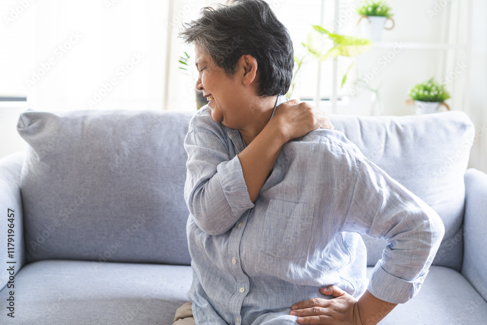 Pain body muscles stiff problem, suffer asian senior woman painful, older hand holding neck ache and aged holding massaging rubbing body, injury hurt,sore sitting on sofa at home. Health care concept. Pain body muscles stiff problem, suffer asian senior woman painful, older hand holding neck ache and aged holding massaging rubbing body, injury hurt,sore sitting on sofa at home. Health care concept.