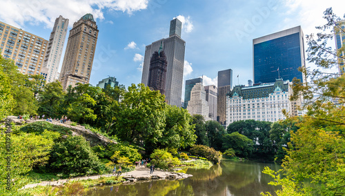 A view from the Gapstow Bridge across the pond towards the skyscrapers around Central Park in Manhattan, New York, in the fall
 photo