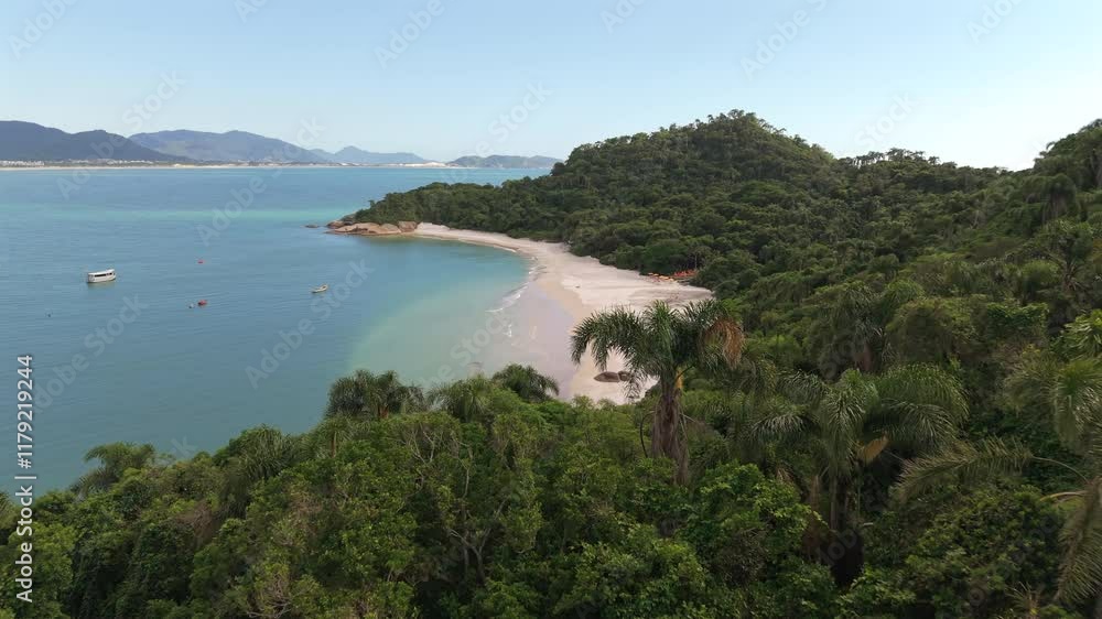 Drone flight over Campeche Island, revealing the stunning and famous beach with crystal-clear waters, a tropical paradise in Santa Catarina, Brazil. Drone flight over Campeche Island, revealing the stunning and famous beach with crystal-clear waters, a tropical paradise in Santa Catarina, Brazil.