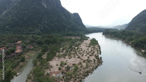 Circular drone footage above the remote village of Muang Ngoi in north Laos, heavily bombed during the secret war with CIA. Camera is moving from right to left 1-2
