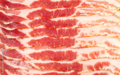 Smoked raw British dry cured streaky bacon rashers background texture photo