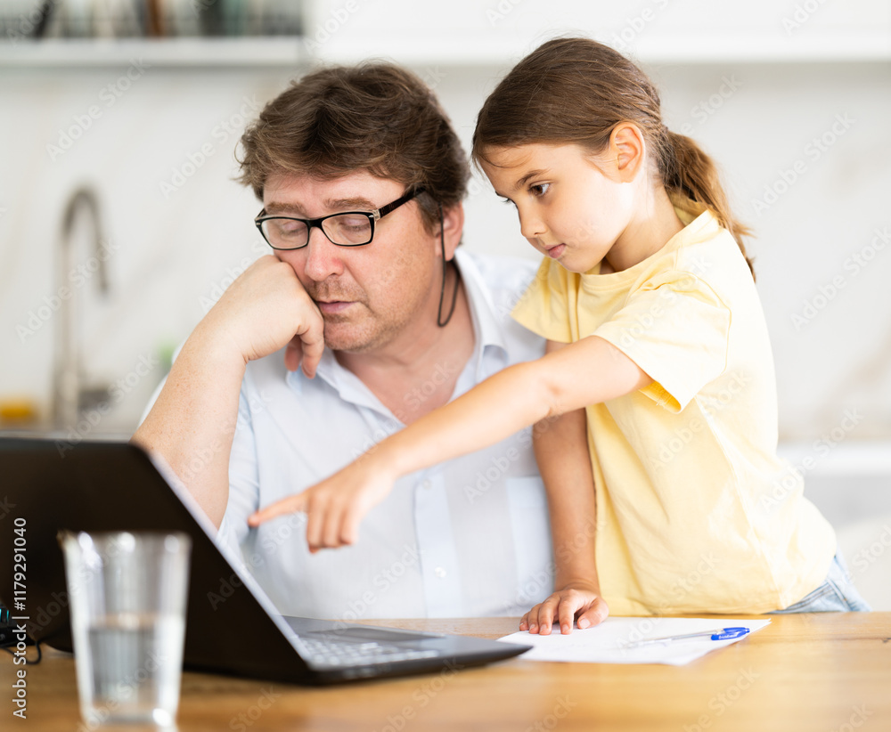 Little daughter shows her father how to use laptop Little daughter shows her father how to use laptop