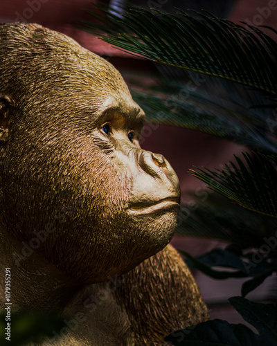 Golden statue of a gorilla looking placid and contemplating
