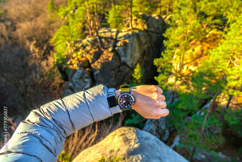 POV Human Arm Showing Casio Wrist Watch on Top of Mountain While Taking Break. Forest and hills distant, aspen trees in autumntime photo