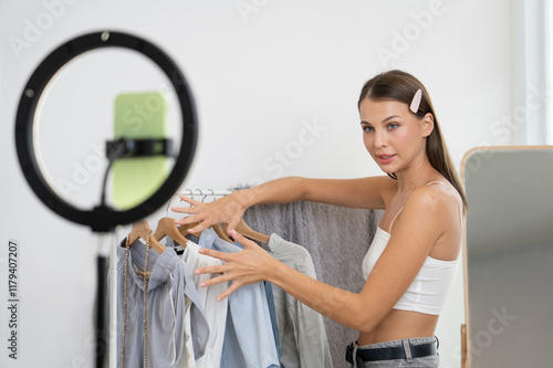 Фотография Young woman making fashion video content for social media