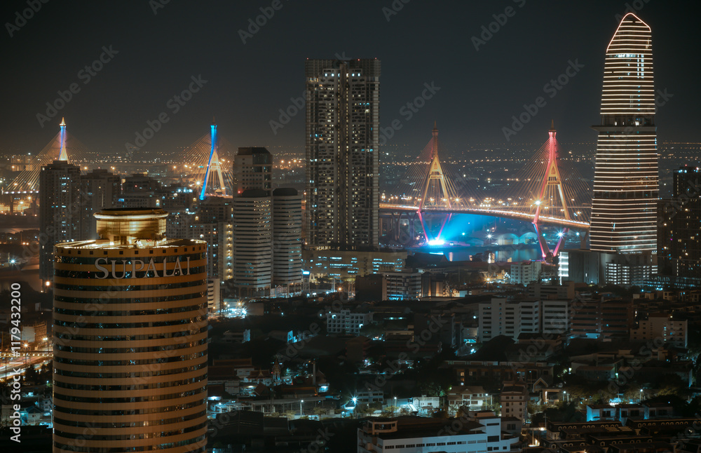 Night view after sunset of Skyscrapers in the business district and Bhumibol Bridge. Beautiful city of Bangkok with bright glowing lights in the sundown, use it as your Wallpaper,Poster and Copy space