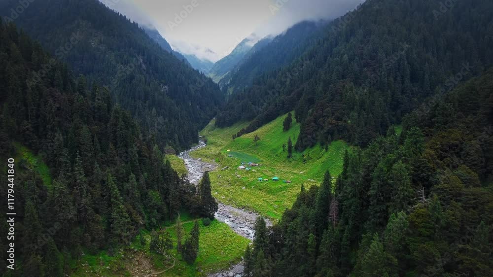 beautiful drone shot over the Himalayan mountain valley with glacial river flowing swiftly & mountains are covered with monsoon vegetation and pine trees in Himachal Pradesh, India beautiful drone shot over the Himalayan mountain valley with glacial river flowing swiftly & mountains are covered with monsoon vegetation and pine trees in Himachal Pradesh, India