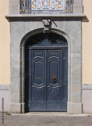 Baroque portal with wooden door at the royal cloth manufacture building in the old town of Carcassonne, France photo