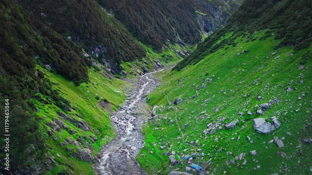 beautiful drone shot over the Himalayan mountain valley with glacial river flowing swiftly & mountains are covered with monsoon vegetation and pine trees in Himachal Pradesh, India beautiful drone shot over the Himalayan mountain valley with glacial river flowing swiftly & mountains are covered with monsoon vegetation and pine trees in Himachal Pradesh, India