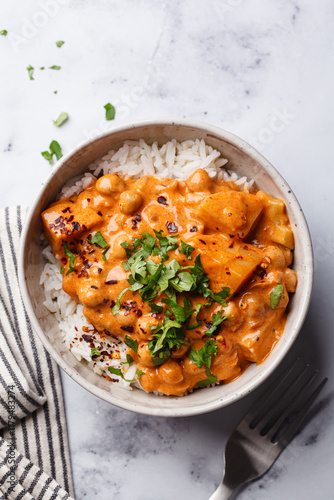 Vegan curry chickpea stew with vegetables in white bowl.