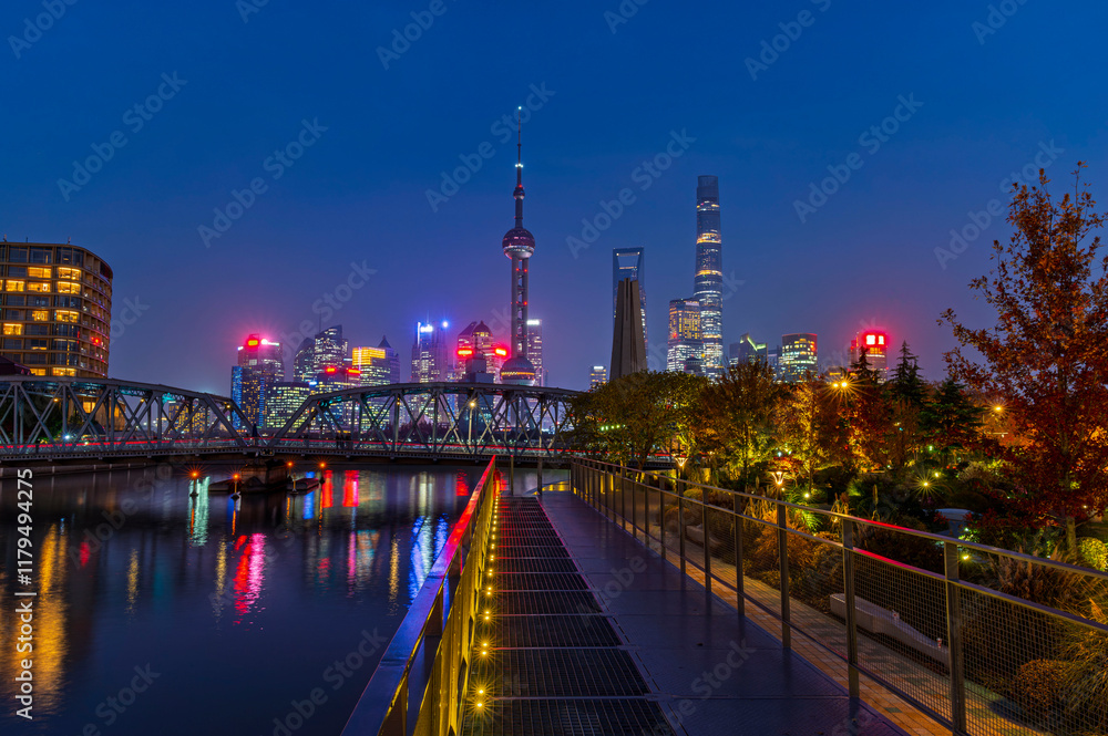 Sunset of Shanghai city modern skyscraper night light cityscape in twilight blue sky in autumn season behind pollution haze, view from the bund in Shanghai, China.