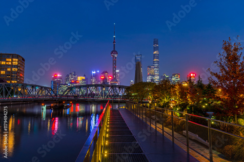 Obraz na płótnie Sunset of Shanghai city modern skyscraper night light cityscape in twilight blue sky in autumn season behind pollution haze, view from the bund in Shanghai, China. w salonie