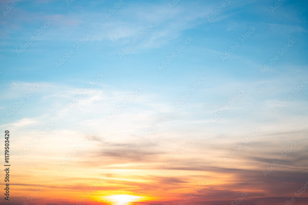 Obraz premium Sky,sunset, beautiful , luxury soft gradient orange gold clouds and sunlight on the blue sky perfect for the background, Sunrise on morning or everning in winter warm time ,Twilight summer,silhouette