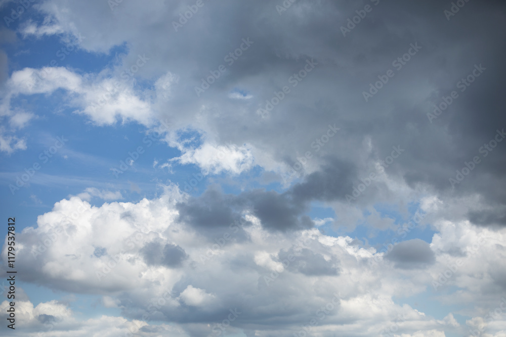 Blue sky background with rain clouds. Cumulus clouds in the blue sky.
Blue sky background with rain clouds. Cumulus clouds in the blue sky.