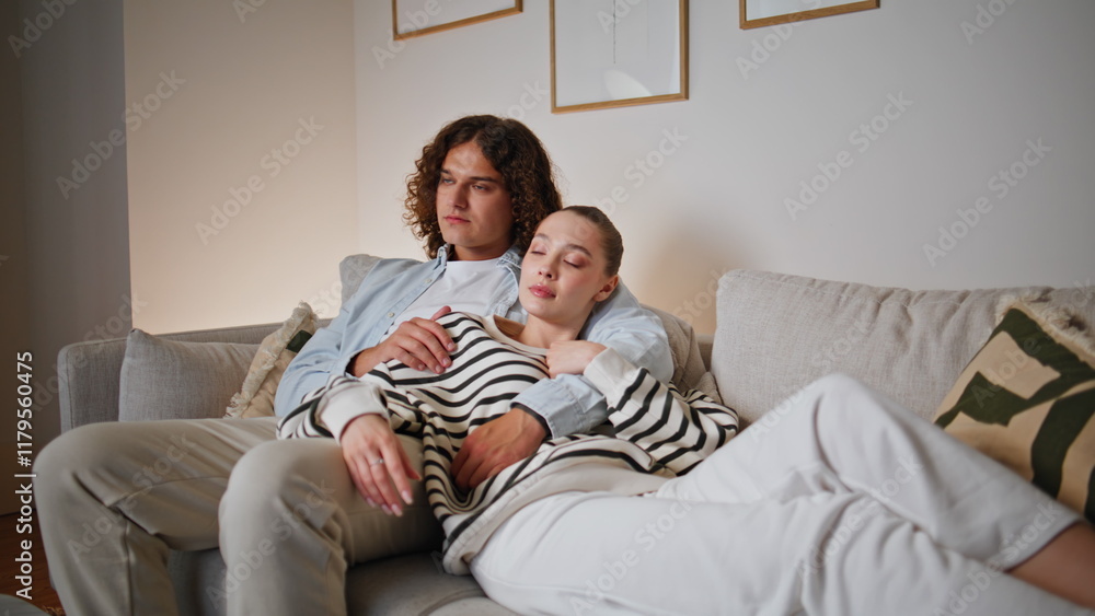 Bonding couple watching TV at comfortable home sofa closeup. Relaxed spouses Bonding couple watching TV at comfortable home sofa closeup. Relaxed spouses