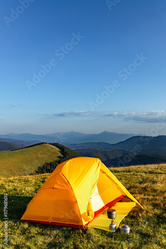 Hiking in the mountains in summer with a tent. Beautiful sunset in the mountains.