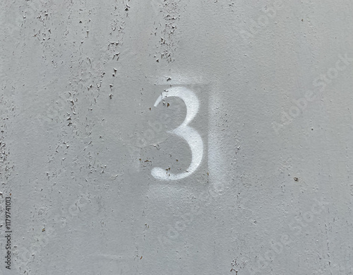White number 3 on aged background. Three on textured gray surface 