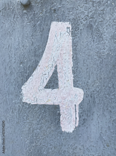 White number 4 on aged gray background. Four on textured surface with old paint