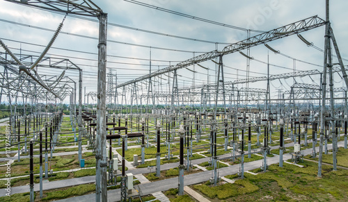 Aerial view of a large electrical power substation under a cloudy sky
