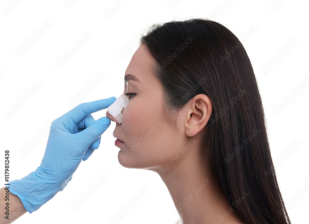 Doctor checking patient's nose after plastic surgery operation on white background, closeup Doctor checking patient's nose after plastic surgery operation on white background, closeup