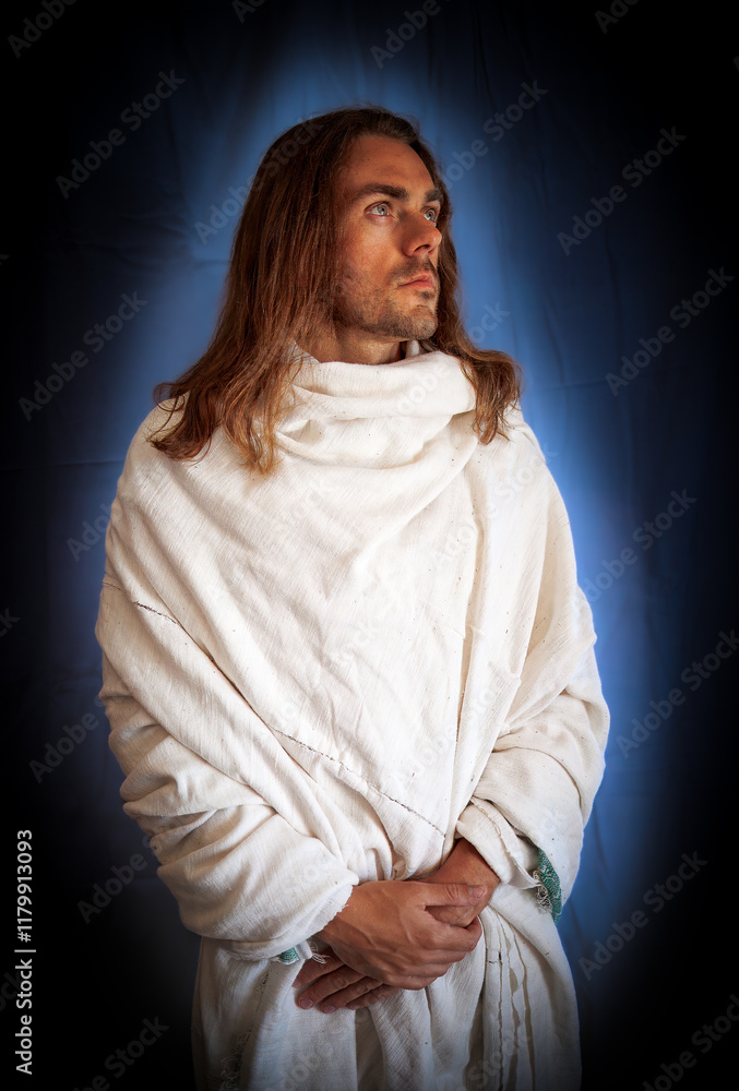 Good-looking, long-haired man with a beard and a blue halo dressed in a robe like a spiritual Christ-like man