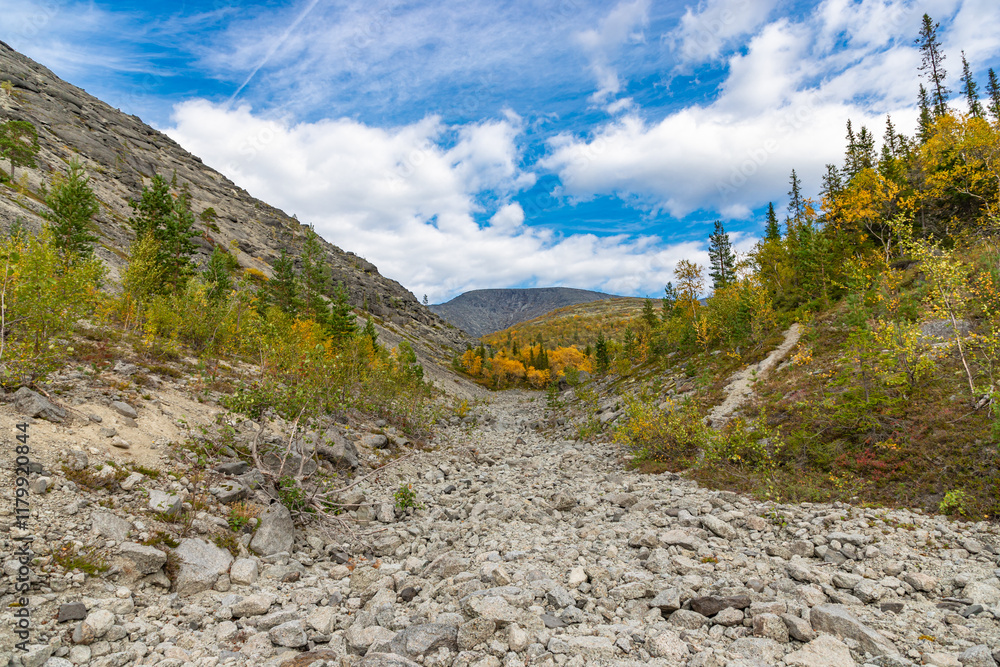 View to Khibiny mountains near Mannepakhp river. Early autumn in arctic tundra region. Kola peninsula, Murmansk region, Russia.