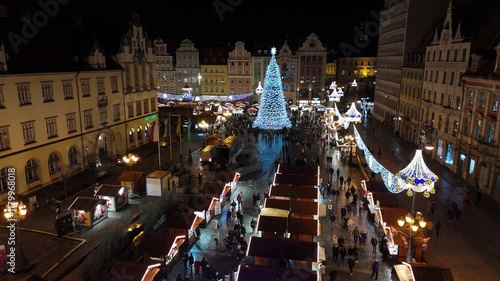 Aerial video from a drone flying over the central historical tourist part of the city of Wroclaw in New Year's illumination on a Christmas winter evening, Poland - old market and city hall