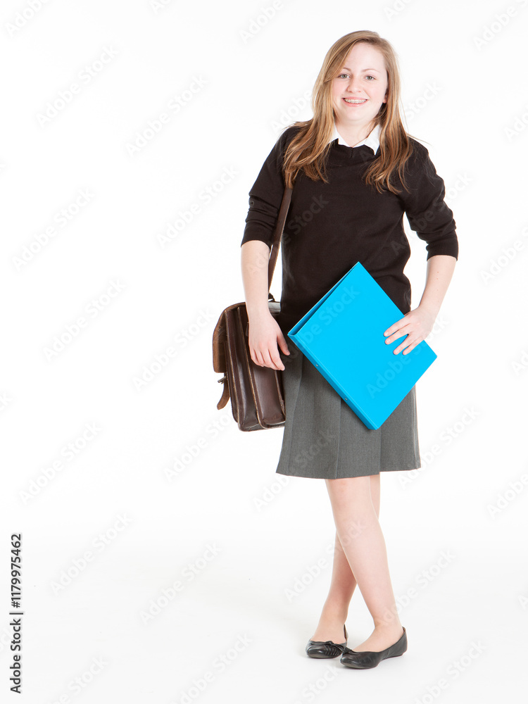 Early Teenage Students: Smiling Girl. An early teenage girl in school unifom with bag and folder isolated against a white background. Early Teenage Students: Smiling Girl. An early teenage girl in school unifom with bag and folder isolated against a white background.