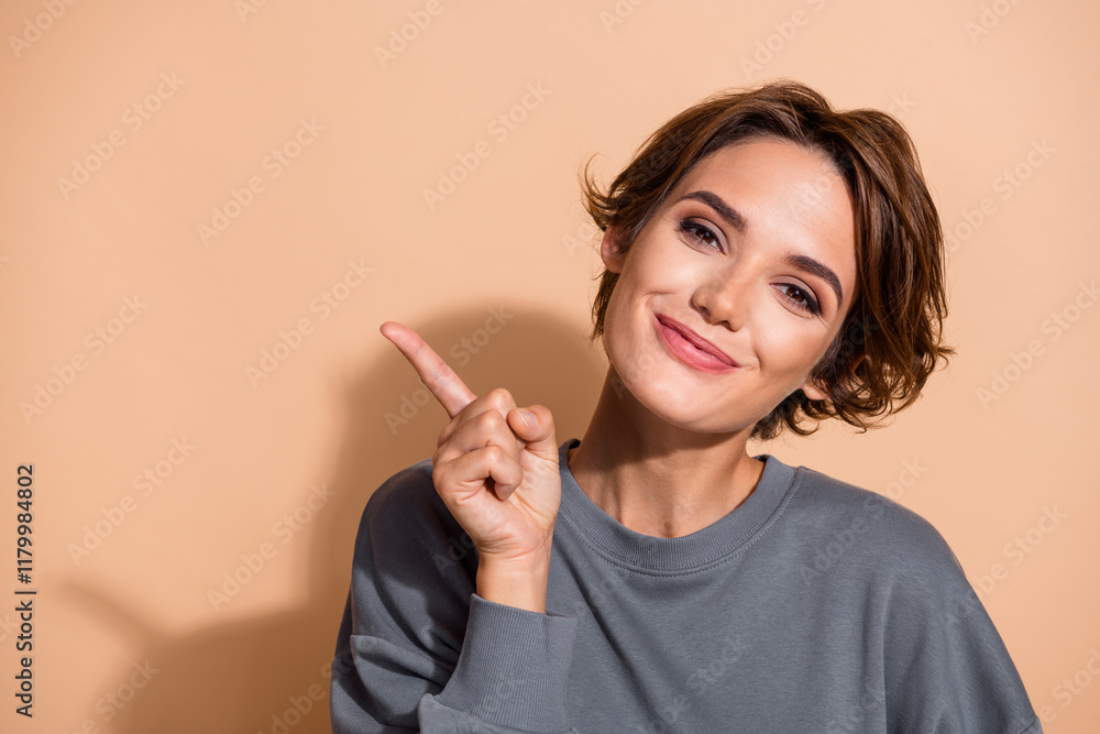 Obraz premium Photo portrait of pretty young girl point charming cute empty space wear trendy gray outfit isolated on beige color background