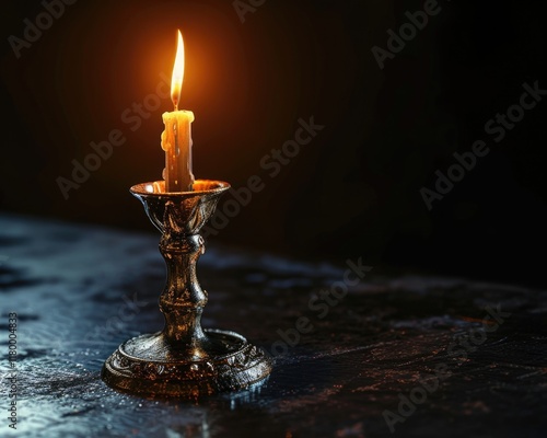 Vintage Silver Candlestick Holder Illuminated on Black Background with Burning Candle photo