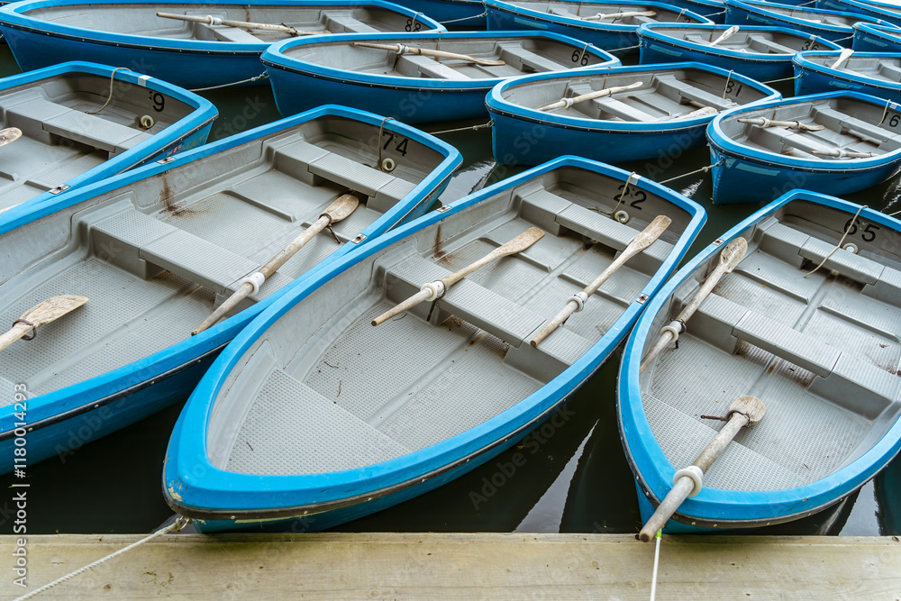 Blue boats at the dock on Katsura river in Arashiyama district, Kyoto. Blue boats at the dock on Katsura river in Arashiyama district, Kyoto.