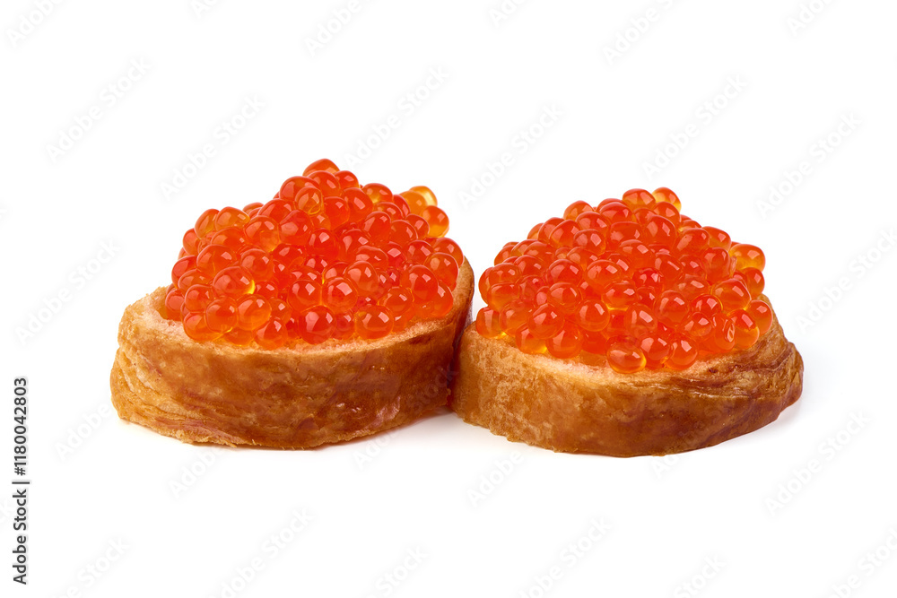 Red caviar on a crispy bread slice, isolated on white background. Red caviar on a crispy bread slice, isolated on white background.