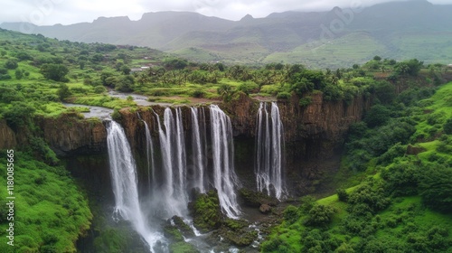 Majestic Waterfall Cascading Through Lush Green Mountains