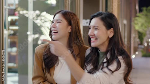 Wallpaper Mural Women enjoying night out in city, filled with laughter and excitement as they point at urban landscape, celebrating joy and friendship outdoors. Asian businesswoman lifestyle Torontodigital.ca