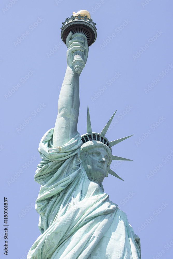 Fototapeta premium Closeup of the Statue of Liberty on the Liberty Island in New York against a clear blue sky.