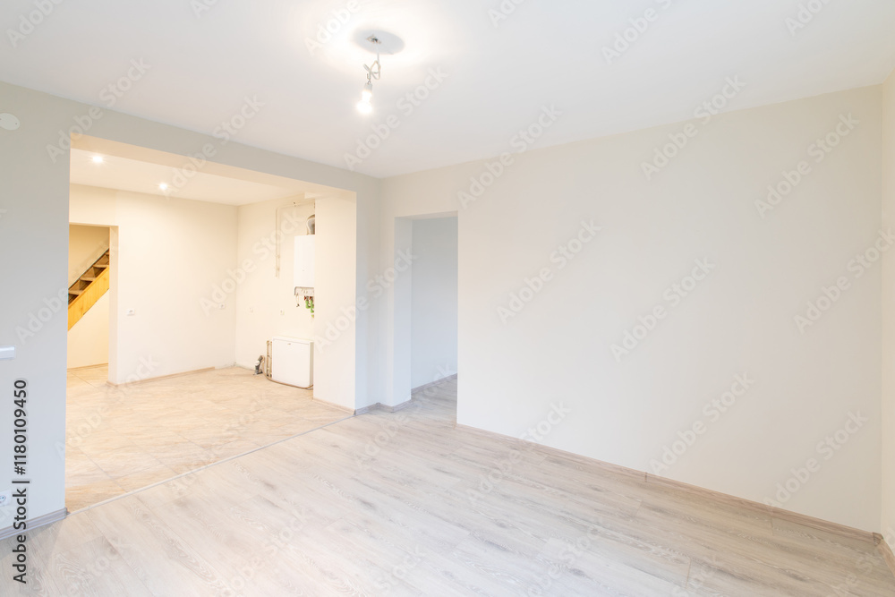 Bright Modern Empty Room With Wooden Flooring and Neutral Interiors. New Construction Home Interior Bright Modern Empty Room With Wooden Flooring and Neutral Interiors. New Construction Home Interior