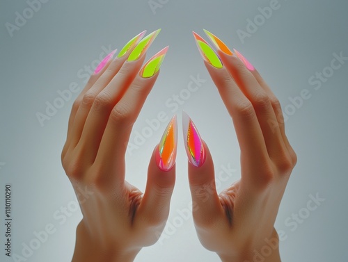 Photograph of two hands with neon stiletto nails in gradient tones photo