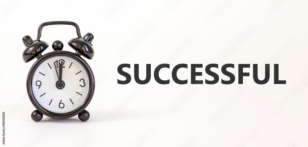 Successful symbol. Concept word Successful on beautiful white paper. Beautiful white paper background. Black alarm clock. Business successful concept. Copy space. Successful symbol. Concept word Successful on beautiful white paper. Beautiful white paper background. Black alarm clock. Business successful concept. Copy space.