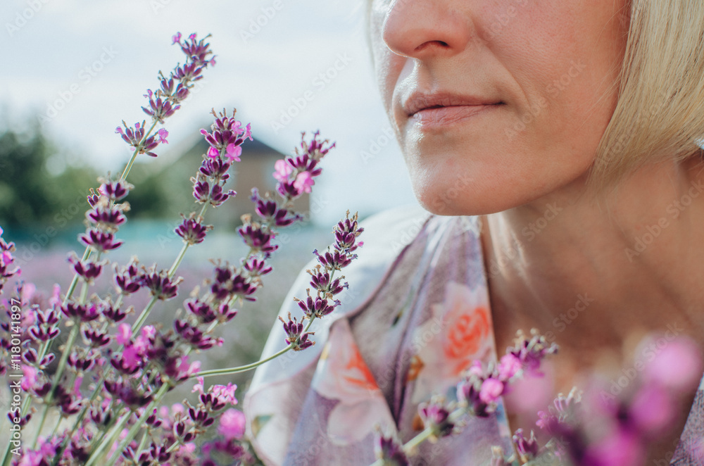 Fototapeta premium close-up of lavender flowers with a woman in the background