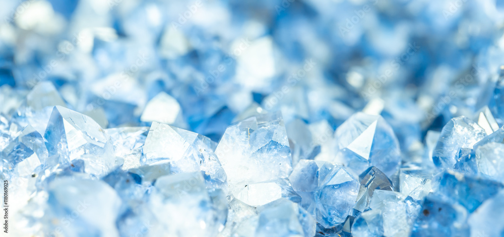 Obraz premium Blue Crystal Mineral Stone. Gems. Mineral crystals in the natural environment. Texture of precious and semiprecious stones. Seamless background with copy space colored shiny surface of precious stones