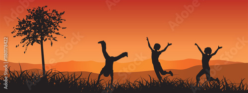 Silhouette image of children playing in nature against the background of sunset.