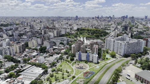 Drone flies north from La Bombonera toward Lezama Park on sunny afternoon in Buenos Aires, Argentina photo